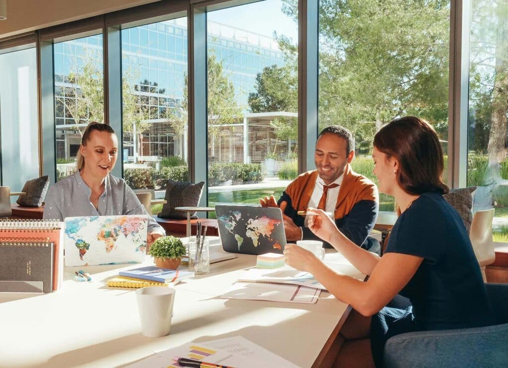 Team of entrepreneurs collaborating on strategic business planning in a modern office with natural light.